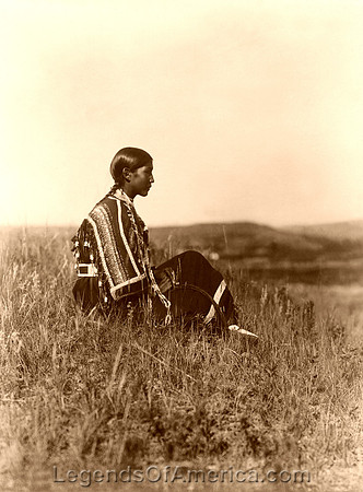 Piegan woman seated on the hill, 1910